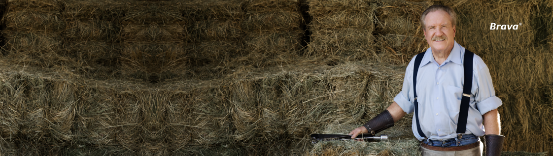 An elderly man in a barn