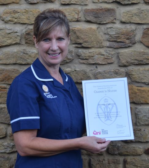 Nurse Wendy Osbourne holding certificate 